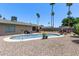 Enjoy a refreshing dip in this backyard pool, surrounded by palm trees and gravel, perfect for hot summer days at 1809 S Heritage --, Mesa, AZ 85210