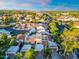 An aerial shot displays homes with red tile roofs in a community with mountain views on the horizon at 1913 S River Dr, Tempe, AZ 85281