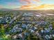 Expansive aerial view of a residential neighborhood at sunset with lush greenery and a community pool at 1913 S River Dr, Tempe, AZ 85281