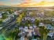 Aerial view displays homes near a green landscape, road, and picturesque horizon at 1913 S River Dr, Tempe, AZ 85281