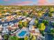 An aerial view showcases the neighborhood with beautiful homes, mature trees, and a community pool at 1913 S River Dr, Tempe, AZ 85281