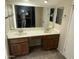 Bathroom with double sink vanity, large mirror and tile floors at 1913 S River Dr, Tempe, AZ 85281