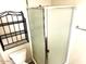 Bathroom featuring frosted glass shower and black iron shelving unit for ample storage and style at 1913 S River Dr, Tempe, AZ 85281