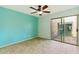 Bedroom features tile floors, ceiling fan, and sliding glass door to the patio at 1913 S River Dr, Tempe, AZ 85281
