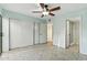 Bright bedroom offers tile floors, ceiling fan, and closet space at 1913 S River Dr, Tempe, AZ 85281