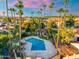 Relaxing community pool surrounded by lush landscaping and towering palm trees, perfect for enjoying warm weather at 1913 S River Dr, Tempe, AZ 85281