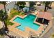 Aerial view of a community pool with unique layout, lounge area, and mature palm trees at 1913 S River Dr, Tempe, AZ 85281