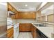 Well-organized kitchen layout with a range, sink, and plentiful cabinet storage, offering efficiency and convenience at 1913 S River Dr, Tempe, AZ 85281