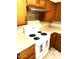 Well-lit kitchen featuring light countertops, oak cabinets, and modern appliances for delightful cooking and easy cleanup at 1913 S River Dr, Tempe, AZ 85281