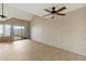Bright living room features tile floors, ceiling fan, and sliding glass doors to the backyard at 1913 S River Dr, Tempe, AZ 85281