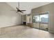 Spacious living room boasts tile floors, ceiling fan, and sliding glass doors to the backyard at 1913 S River Dr, Tempe, AZ 85281