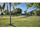Beautiful community park featuring lush green grass, mature trees, a playground, and picnic benches at 1913 S River Dr, Tempe, AZ 85281