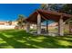 Shaded picnic area with a covered gazebo, concrete table, and lush green lawn, surrounded by residences at 1913 S River Dr, Tempe, AZ 85281