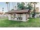 Outdoor picnic area featuring a covered gazebo with table and benches on a well-maintained lawn at 1913 S River Dr, Tempe, AZ 85281