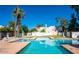 Community pool surrounded by lush landscaping and lounge chairs at 1913 S River Dr, Tempe, AZ 85281