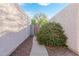 Tranquil walkway to home featuring desert landscaping, stucco walls, and a gated entrance for added privacy at 1913 S River Dr, Tempe, AZ 85281