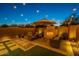 Cozy backyard with a fireplace, comfortable seating, and string lights creating an inviting ambiance at 1956 W Kinfield Trl, Phoenix, AZ 85085