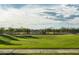 Community basketball court with shaded seating and expansive lawn area, perfect for recreation and relaxation at 1956 W Kinfield Trl, Phoenix, AZ 85085