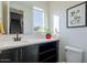 Bright bathroom with a modern vanity, decorative plant and artwork enhancing its appeal at 1956 W Kinfield Trl, Phoenix, AZ 85085