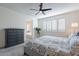 Serene bedroom featuring natural light, a decorative dresser, and a glimpse into an adjoining bathroom space at 1956 W Kinfield Trl, Phoenix, AZ 85085