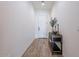 Bright entryway with wood-look tile flooring, a decorative table, and fresh white walls at 1956 W Kinfield Trl, Phoenix, AZ 85085