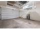 Spacious garage with overhead storage racks and ample room for vehicles and storage at 1956 W Kinfield Trl, Phoenix, AZ 85085