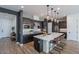Sleek kitchen features modern cabinets, stainless steel appliances, and a large island with seating at 1956 W Kinfield Trl, Phoenix, AZ 85085