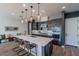 Bright kitchen showcasing a spacious island with bar seating, stainless appliances, modern lighting, and stylish backsplash at 1956 W Kinfield Trl, Phoenix, AZ 85085