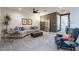 Spacious living room with a comfortable sectional sofa, modern decor, and plush carpeting for a welcoming ambiance at 1956 W Kinfield Trl, Phoenix, AZ 85085
