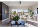 Cozy living room with patio access, stylish furniture, and natural light, perfect for relaxing at 1956 W Kinfield Trl, Phoenix, AZ 85085