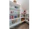 Organized walk-in pantry with ample shelving for storage, showcasing a variety of food items and kitchen essentials at 1956 W Kinfield Trl, Phoenix, AZ 85085