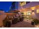 Beautiful outdoor living space with a covered patio, stylish furniture, and lush landscaping at 1956 W Kinfield Trl, Phoenix, AZ 85085