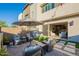 Inviting backyard patio with comfortable seating, an umbrella, and seamless indoor-outdoor flow at 1956 W Kinfield Trl, Phoenix, AZ 85085