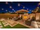 Stylish outdoor patio with a charming fireplace, cozy seating, and elegant landscaping, perfect for relaxing evenings at 1956 W Kinfield Trl, Phoenix, AZ 85085