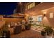 Cozy patio with seating area, umbrella, BBQ grill, and lush artificial turf, great for entertaining guests at 1956 W Kinfield Trl, Phoenix, AZ 85085