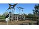 Community playground with climbing structure, slides, and soft surface for to enjoy at 1956 W Kinfield Trl, Phoenix, AZ 85085