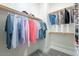 Walk-in closet featuring ample shelving and hanging space for organized storage at 1956 W Kinfield Trl, Phoenix, AZ 85085