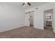 Bedroom with neutral carpet, barn door leading to a closet and ensuite bathroom at 20100 N 78Th Pl # 2114, Scottsdale, AZ 85255