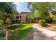 Charming building with lush green landscaping, a welcoming walkway, and mature trees at 20100 N 78Th Pl # 2114, Scottsdale, AZ 85255