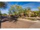 Community entrance with trees and bushes lining the entry at 20100 N 78Th Pl # 2114, Scottsdale, AZ 85255