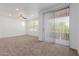 Bright living room featuring neutral carpet, a ceiling fan, and sliding glass doors to a balcony at 20100 N 78Th Pl # 2114, Scottsdale, AZ 85255