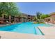 Enjoy the beautiful community pool surrounded by mature trees and foliage, offering a perfect blend of relaxation and natural beauty at 20100 N 78Th Pl # 2114, Scottsdale, AZ 85255