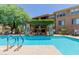 A luxurious pool area featuring shade structures and ample seating, perfect for summer relaxation and socializing at 20100 N 78Th Pl # 2114, Scottsdale, AZ 85255
