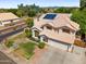 Two-story home featuring a two-car garage, well-maintained lawn, and desert landscaping at 2024 N 125Th Ave, Avondale, AZ 85392