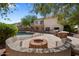 Backyard featuring a pool, fire pit area, a large patio, and BBQ setup at 2024 N 125Th Ave, Avondale, AZ 85392