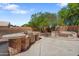 Backyard featuring an outdoor kitchen, BBQ, a built-in seating area with fire pit at 2024 N 125Th Ave, Avondale, AZ 85392