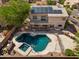 Beautiful backyard view showcases sparkling pool, hot tub, and a second-story deck with solar panels at 2024 N 125Th Ave, Avondale, AZ 85392