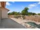 Balcony view overlooking a pool, landscaped yard, and a neighborhood park at 2024 N 125Th Ave, Avondale, AZ 85392