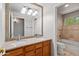 Bathroom with a double sink vanity, large mirror, and separate toilet and shower/tub area at 2024 N 125Th Ave, Avondale, AZ 85392
