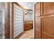 Bathroom detail with block glass and wooden cabinetry at 2024 N 125Th Ave, Avondale, AZ 85392